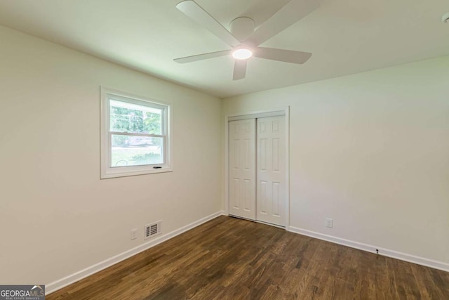 3275 Clifton Church Rd SE, Atlanta, GA 30316 - unfurnished bedroom with dark wood-style flooring, baseboards, a closet, and visible vents