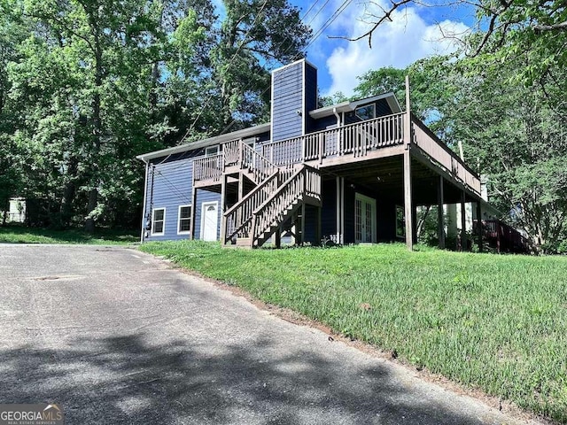 4464 Cary Dr, Snellville, GA 30039 - back of property with a yard, a wooden deck, stairs, and a chimney