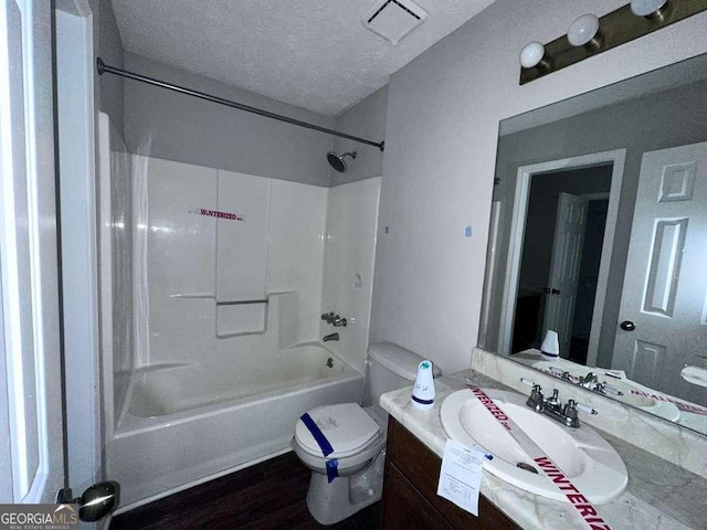 4464 Cary Dr, Snellville, GA 30039 - bathroom featuring toilet,  shower combination, a textured ceiling, visible vents, and vanity