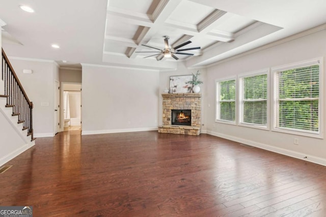 unfurnished living room featuring a ceiling fan, beam ceiling, dark wood finished floors, stairs, and coffered ceiling