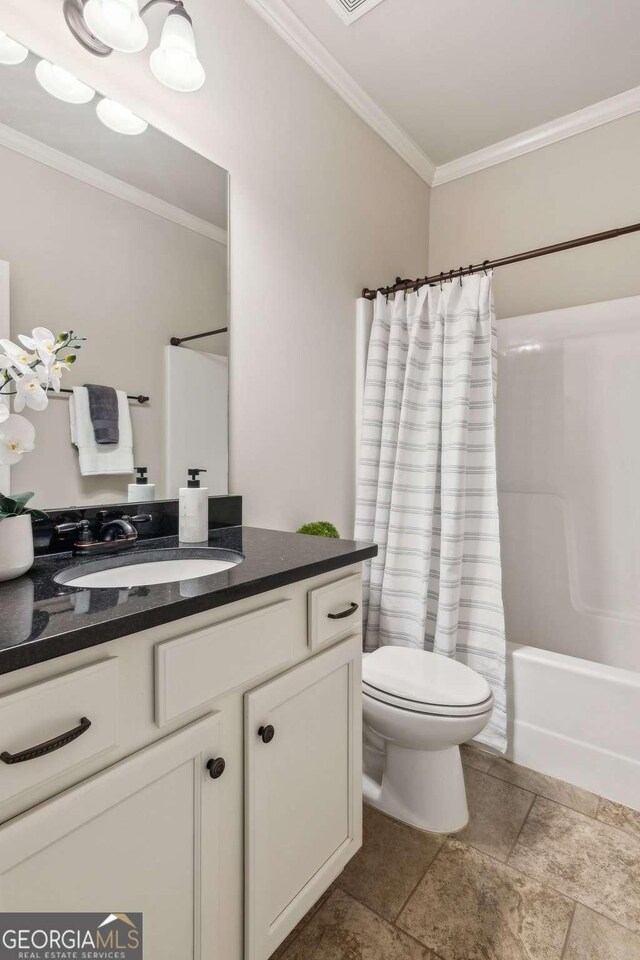 full bathroom with crown molding, toilet, vanity, stone tile floors, and shower / bath combination with curtain