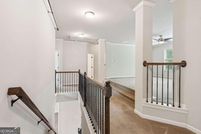 hallway with attic access, an upstairs landing, carpet floors, and decorative columns
