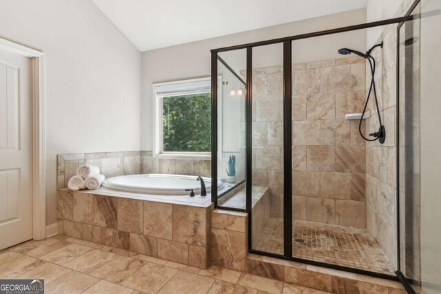 bathroom featuring a shower stall and a bath