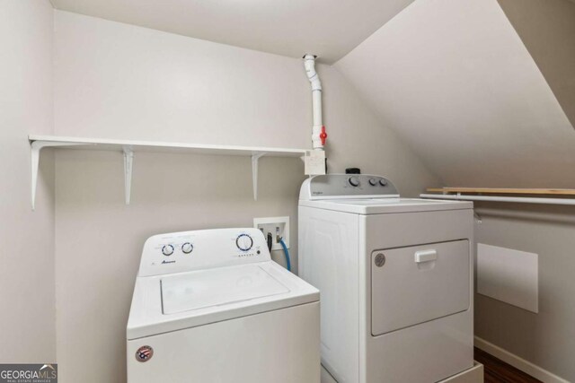 washroom featuring washing machine and clothes dryer and dark wood finished floors