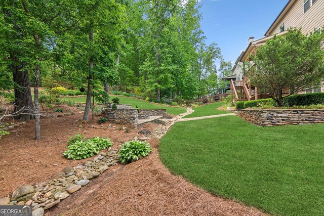 view of green lawn with stairs