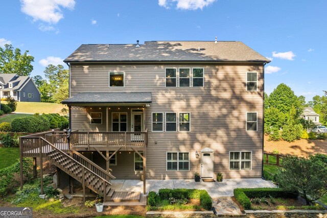 back of house with a deck, a patio area, and stairs