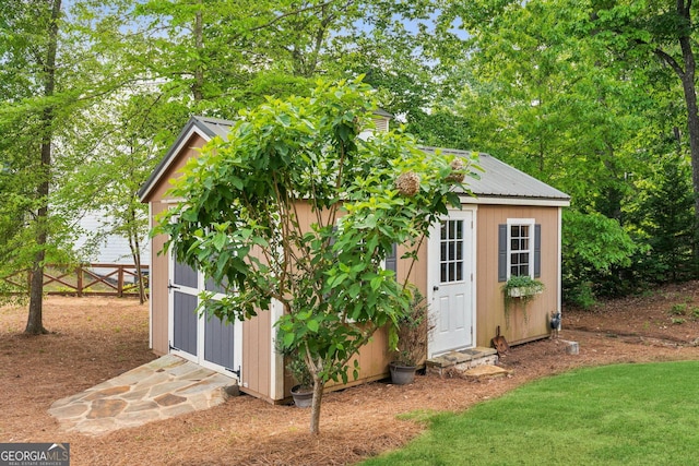view of shed with fence