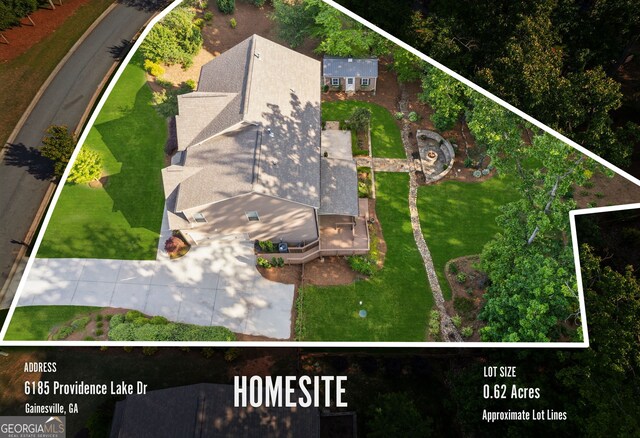 aerial view of property and surrounding area featuring property parcel outlined