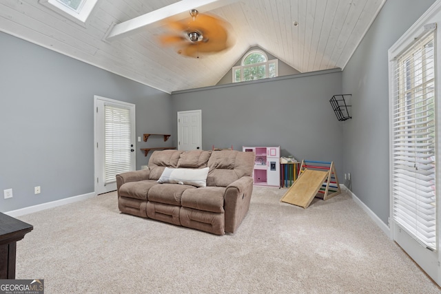 1020 Regency Dr, Acworth, GA 30102 - carpeted living area with lofted ceiling, healthy amount of natural light, a skylight, baseboards, and wood ceiling