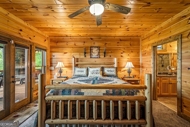 carpeted bedroom with access to outside, wood walls, and wood ceiling