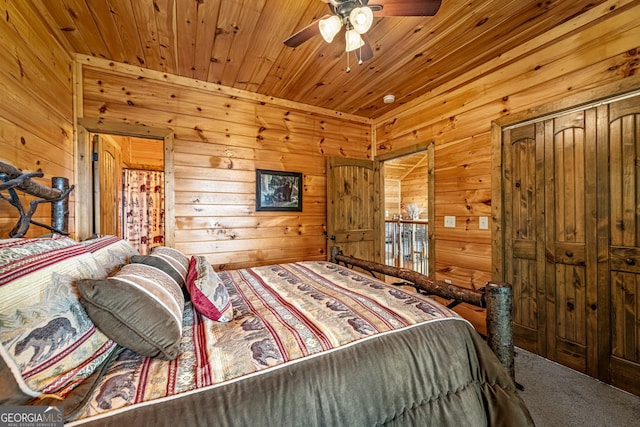 bedroom with wooden walls, carpet flooring, and wooden ceiling