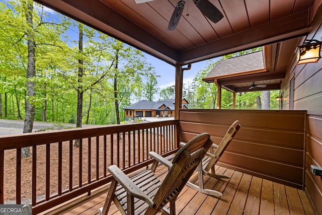 wooden terrace featuring a ceiling fan