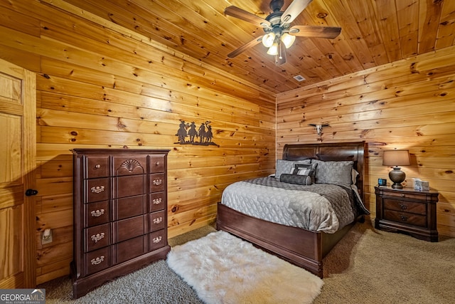 carpeted bedroom with wooden ceiling, wooden walls, and ceiling fan