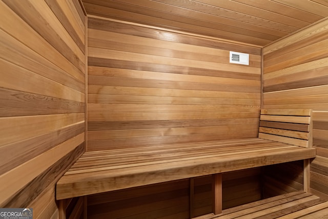 sauna / steam room with wood ceiling and wood walls