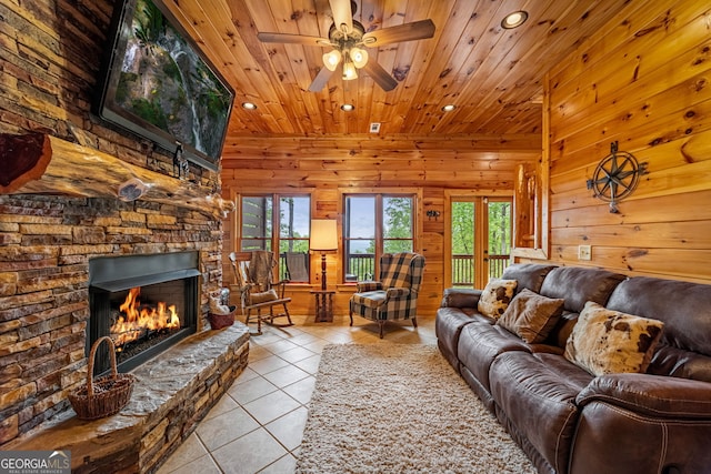 living room with recessed lighting, light tile patterned floors, wooden ceiling, a fireplace, and plenty of natural light