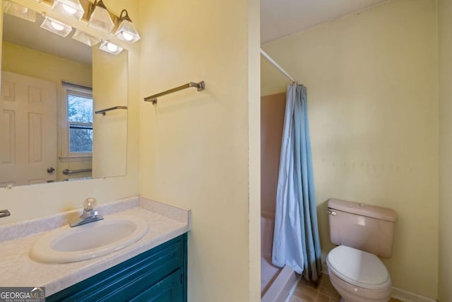 bathroom with a shower with shower curtain, vanity, toilet, and baseboards