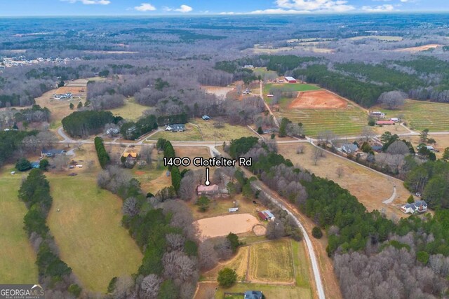 aerial view of property and surrounding area featuring rural landscape