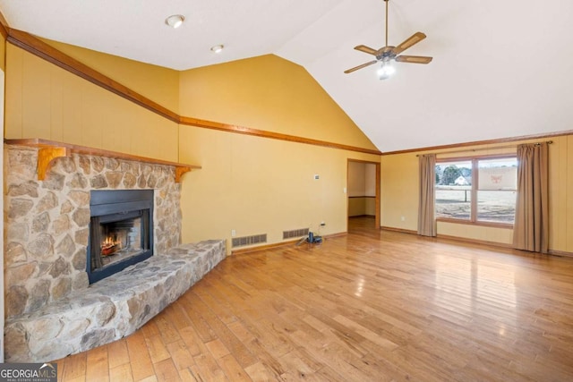 unfurnished living room featuring ceiling fan, light wood-style floors, a fireplace, high vaulted ceiling, and baseboards