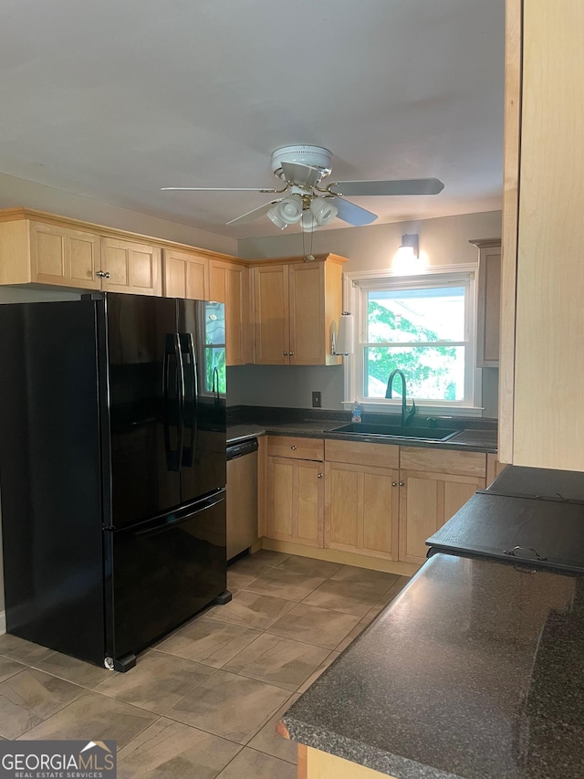 kitchen featuring freestanding refrigerator, light brown cabinetry, dishwasher, a sink, and ceiling fan