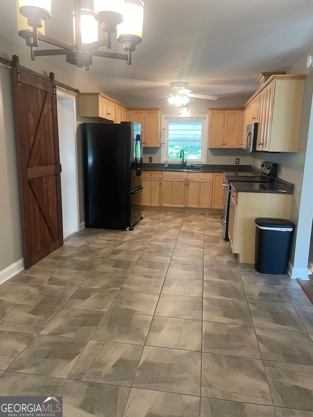 kitchen featuring appliances with stainless steel finishes, a sink, light brown cabinets, dark countertops, and a ceiling fan