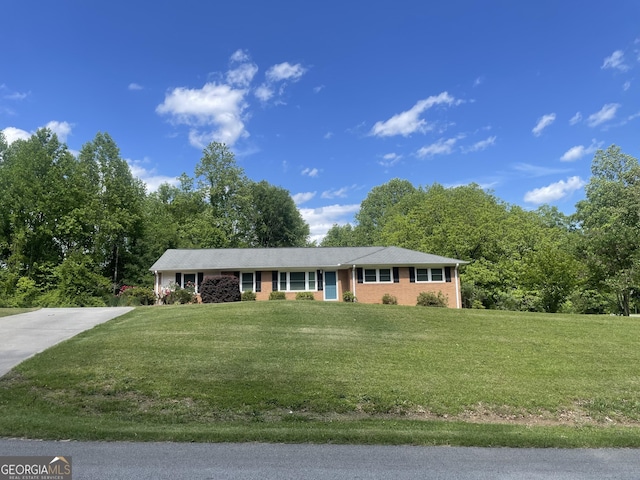ranch-style home with a front yard and driveway