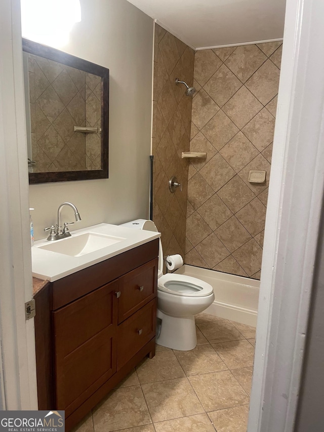bathroom with vanity, toilet, a stall shower, and tile patterned flooring