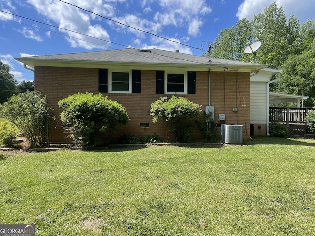 view of home's exterior with a yard, crawl space, central AC, brick siding, and roof with shingles