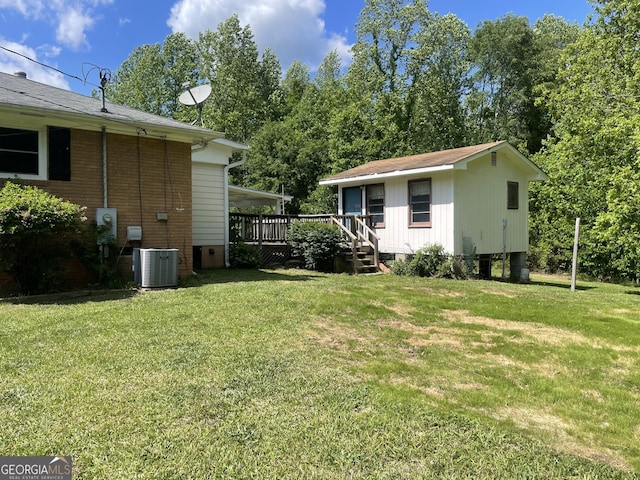 view of grassy yard with cooling unit and a wooden deck