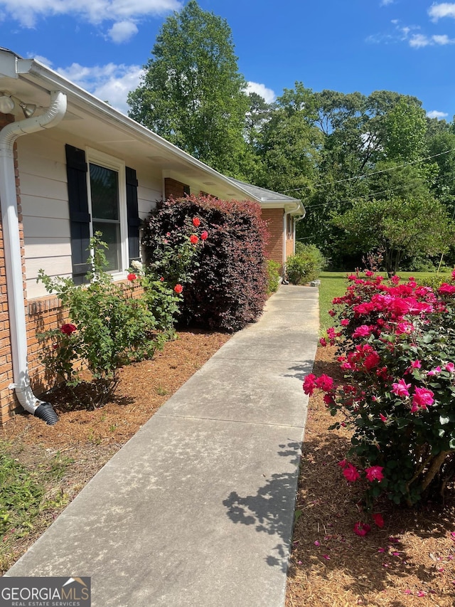 view of side of home with brick siding