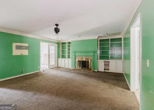 unfurnished living room featuring crown molding, carpet flooring, a brick fireplace, and baseboards