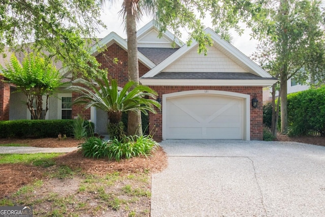 view of front facade featuring concrete driveway, brick siding, a shingled roof, and an attached garage