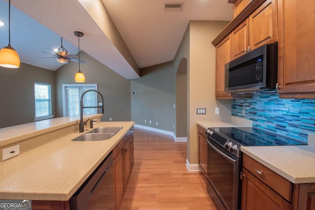 kitchen featuring electric stove, a sink, dishwasher, light wood-type flooring, and ceiling fan