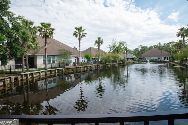 water view featuring fence and nearby suburban area