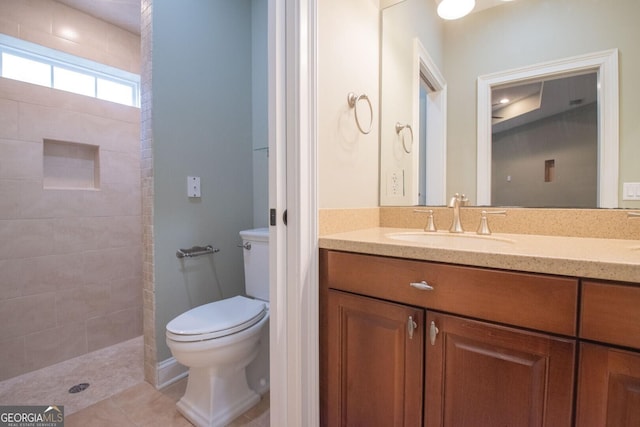 bathroom featuring toilet, walk in shower, vanity, and tile patterned floors