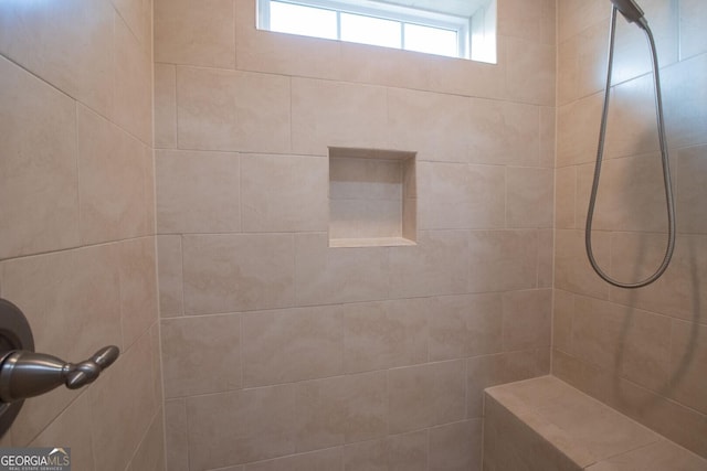 full bath featuring a tile shower