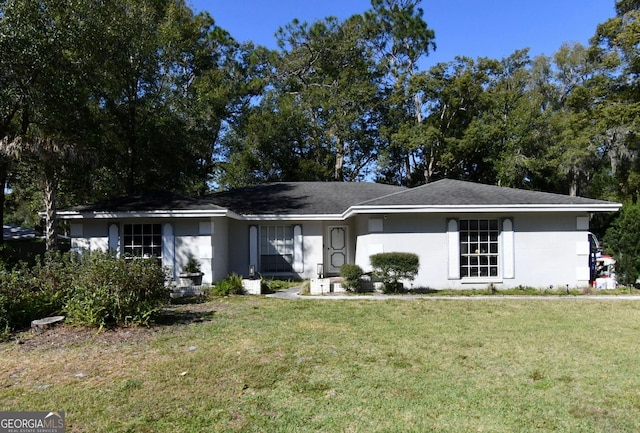single story home with a front lawn and stucco siding