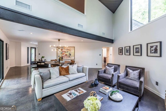 living area with baseboards, a chandelier, a towering ceiling, and recessed lighting