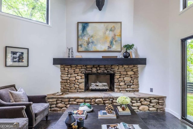 living room with a stone fireplace
