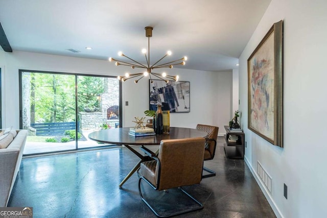 dining area featuring a chandelier and baseboards