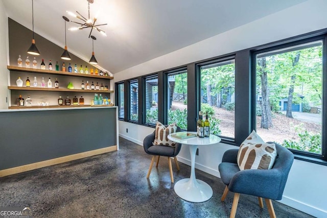 indoor dry bar with baseboards, a chandelier, hanging light fixtures, and lofted ceiling