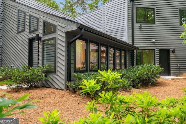 view of side of home featuring a sunroom