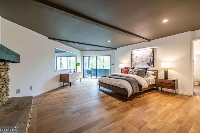 bedroom with access to exterior, a stone fireplace, beam ceiling, light wood finished floors, and recessed lighting