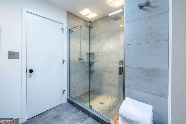 full bathroom featuring a stall shower and tile patterned flooring