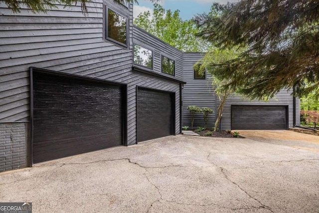 garage with asphalt driveway