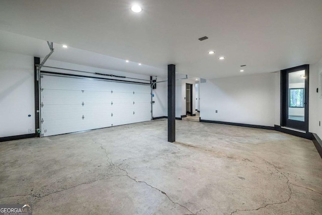 garage featuring recessed lighting and baseboards