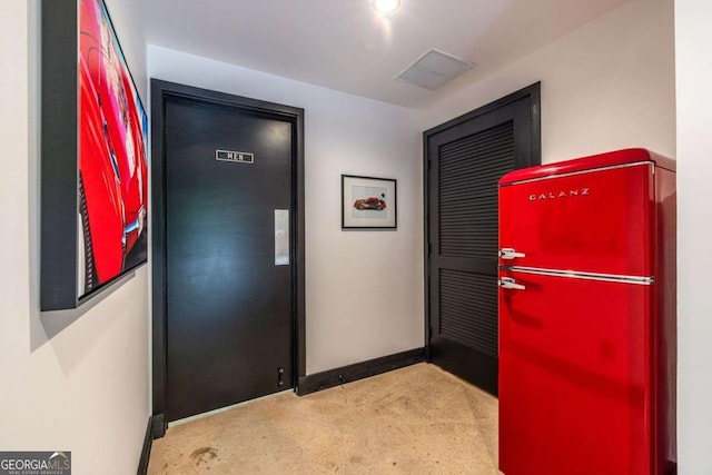 carpeted entrance foyer with baseboards