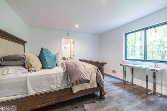 bedroom with wood finished floors, baseboards, and recessed lighting