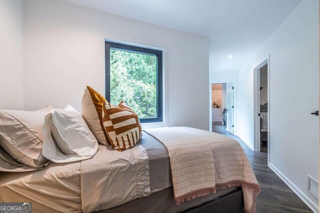 bedroom with wood finished floors, baseboards, and recessed lighting