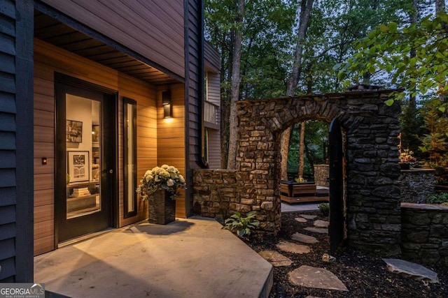 view of exterior entry featuring stone siding