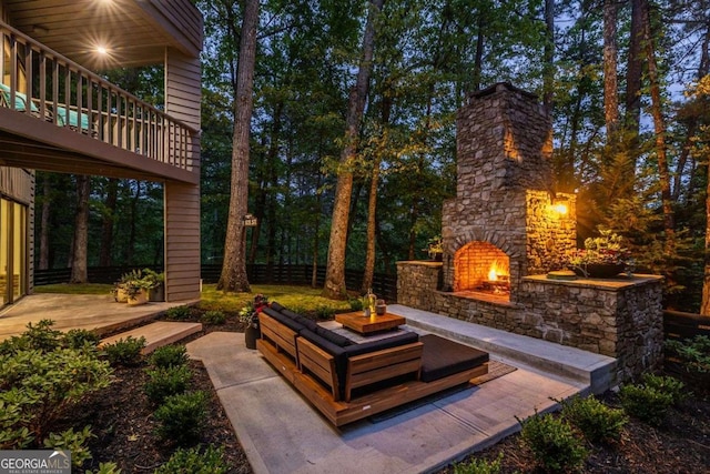view of patio featuring an outdoor stone fireplace
